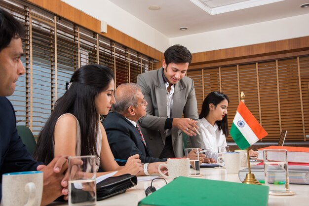 Photo asian indian business people or corporate culture and working in the office concept with laptop, papers, meetings, presentations and discussions