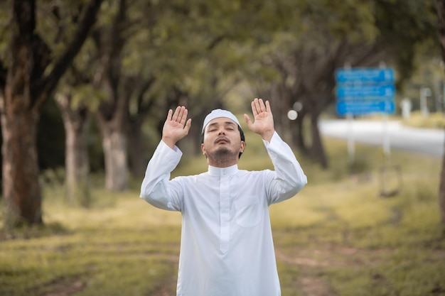 Asian islam man prayerYoung Muslim prayingRamadan festival concept