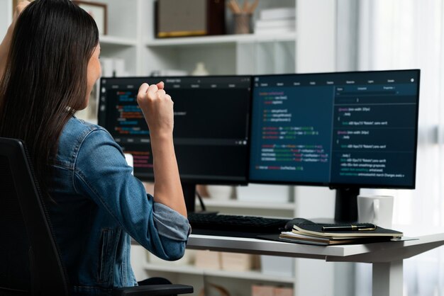 Asian IT developer creating raising fist up with successful project Stratagem