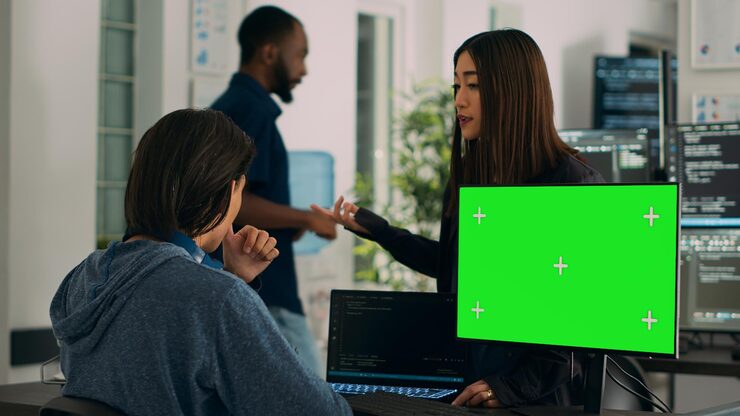 Photo asian it engineers analyzing greenscreen on computer and coding database program with html script. using mockup template with isolated copyspace and chromakey, programming code.