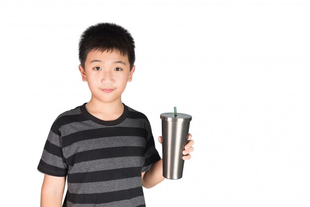 Asian kid boy holding stainless steel tumbler cup with straw