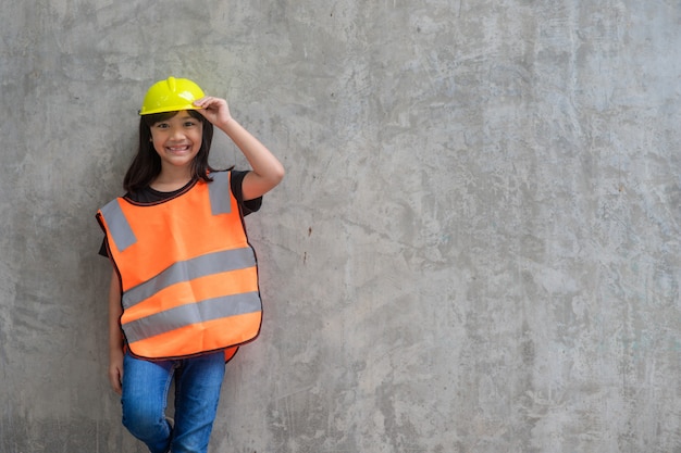 Asian Kid girl wearing reflective shirts and a hat yellow. To learning and enhance development,