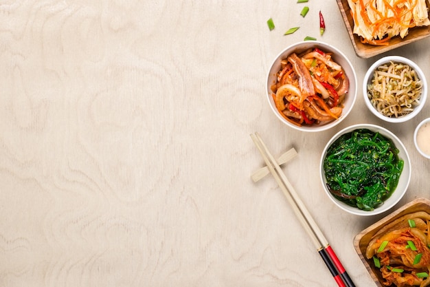 Photo asian korean food and chopsticks on wooden background