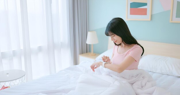 Азиатская дама с умными часами следит за сном