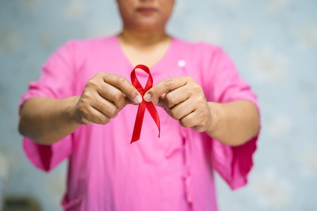 Asian lady woman patient pain and worry her breast in hospital symbol of World Breast Cancer Day