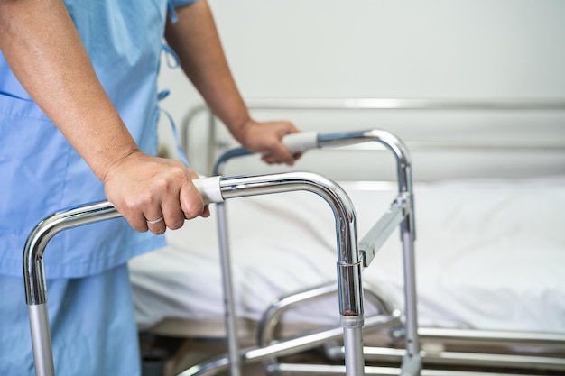 Asian lady woman patient walk with walker at nursing hospital ward healthy strong medical concept