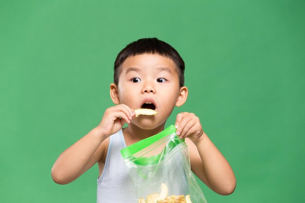 Photo asian little boy eating snack