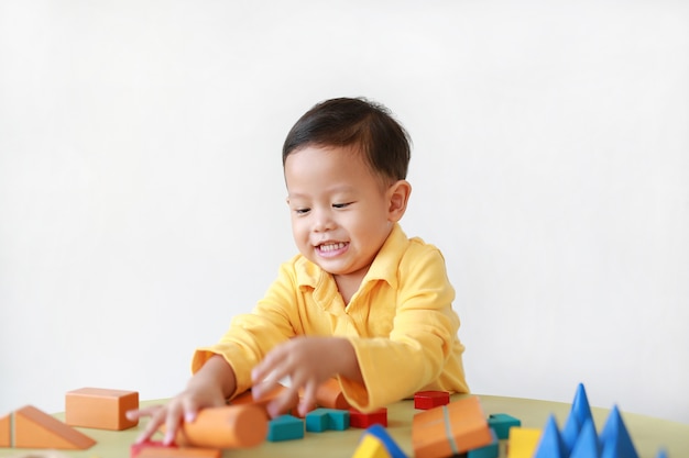 Asian little boy playing with wood toys