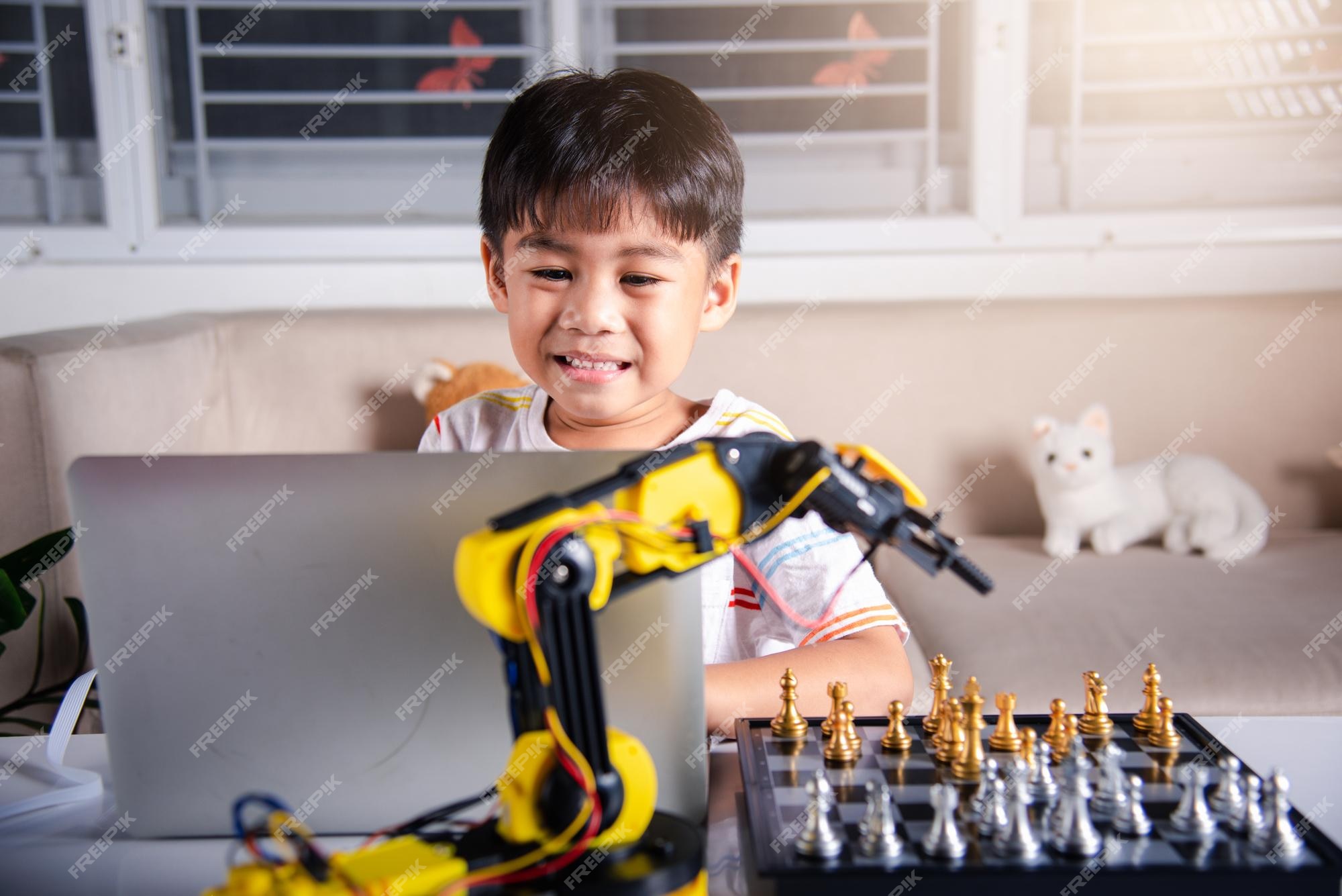 Premium Photo  Asian little boy programming code to robot machine