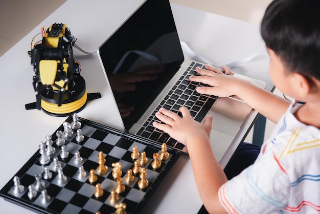 Premium Photo  Asian little boy programming code to robot machine