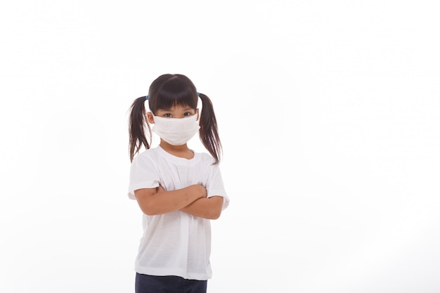 Asian little child girl wearing respirator mask with crossed arms