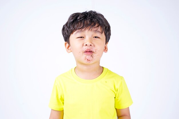 Asian little cute boy eating big donut