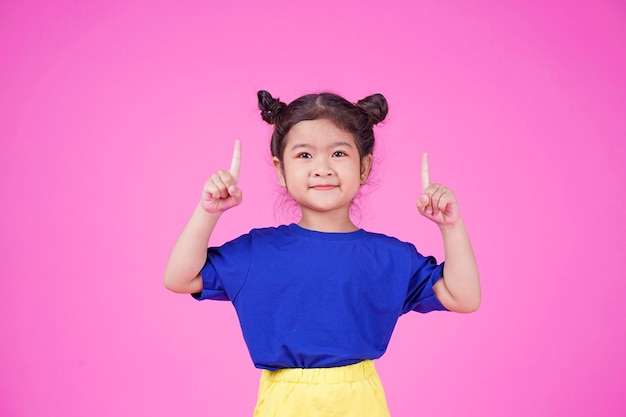 Asian little cute girl pointing something isolated on white background