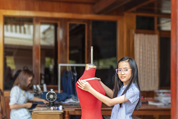Asian little girl dressmaker