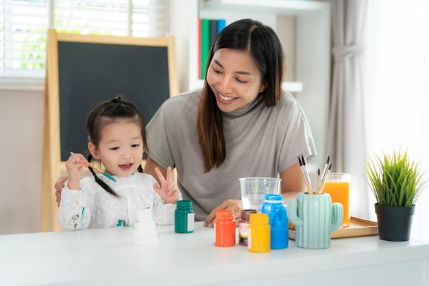 Asian little girl and her mother doing homework