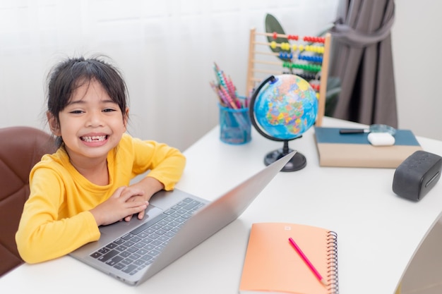 Asian little girl at home doing homework