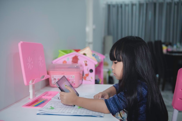 Asian little girl learn online at homeIn the era of the Covid19 epidemic it is not possible to go to school normally