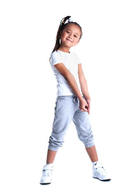 Asian little girl in sportswear isolated