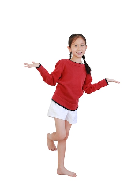 Asian little girl standing on one leg and open hands gesture isolated on white background with clipping path. Full length