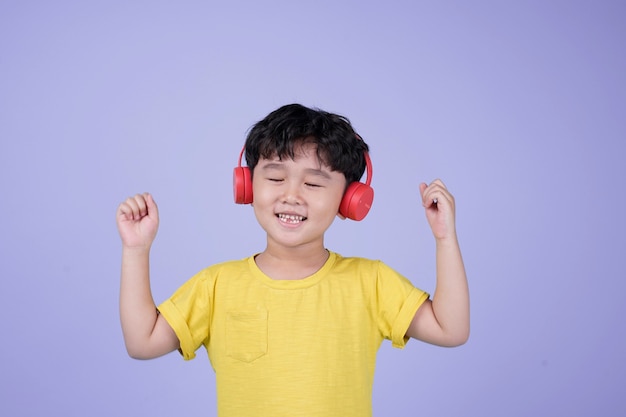 Asian little handsome cute boy with headphone listening to music