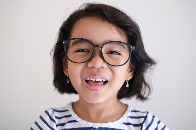 Asian little kid girl wearing glasses and smiling happy