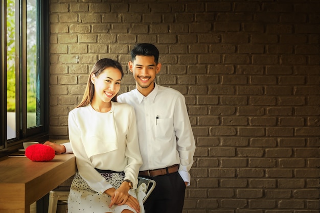 Asian Lover man and woman enjoy with a cup of coffee in coffee shop.