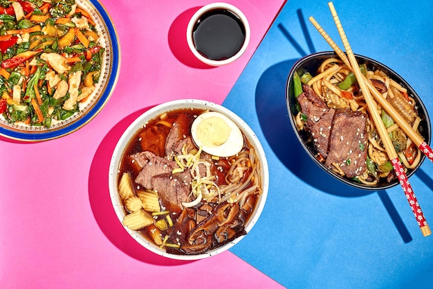 Asian lunch tom yum soup with beef wok noodles and salad on bright backgrounds Menu poster