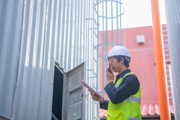 Asian Maintenance engineer at the waste water management system of a huge factorymaintenance checking technical data of heating system equipmentThailand people