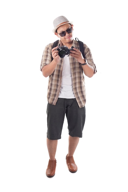 Asian male backpacker photographer tourist Taking Pictures with his mirrorrless