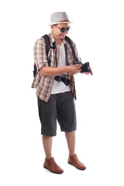 Asian male backpacker tourist wearing hat sunglasses camera and backpack Broke empty wallet