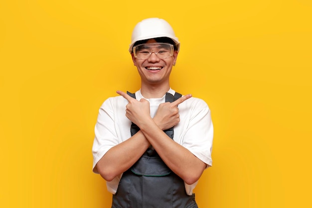 Asian male builder in uniform and safety glasses pointing and choosing from two options