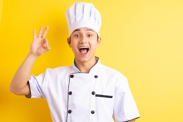 Asian male chef on yellow