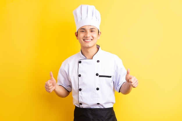 Asian male chef on yellow