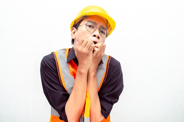 asian male construction worker scared and making frightened gesture. horror concept.