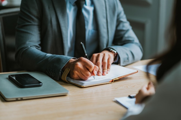 Asian male director is interviewing to recruit new employees