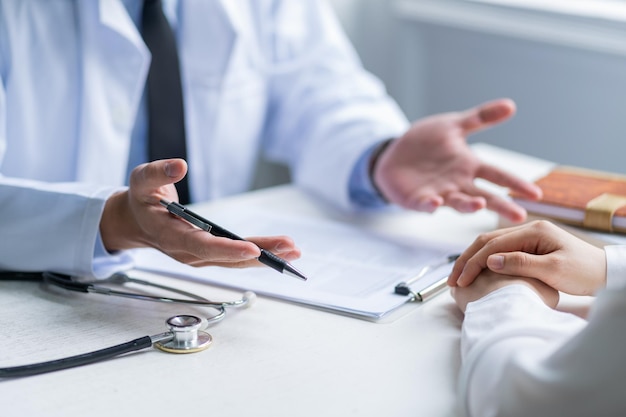 Photo asian male doctor examining patient at clinic