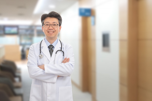 Asian male doctor smiling in the of the hospital