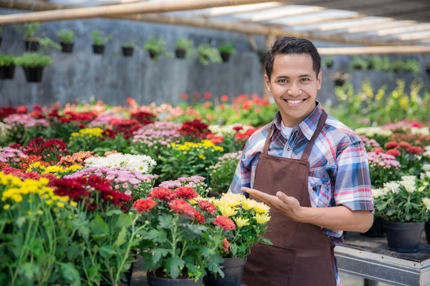 Asian male florist working in flower shop