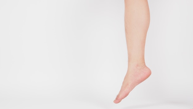 Asian Male leg and barefoot is isolated on white background.