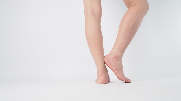 Asian Male legs and barefoot turn around and standing is isolated on white background.