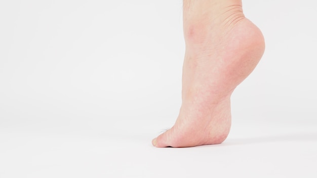 Asian Male's heel and barefoot is isolated on white background.close up shot.