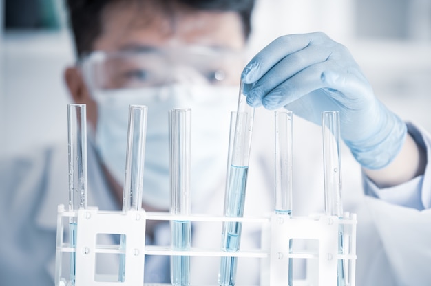 Asian male scientist working in a laboratory. Vaccine development concept.