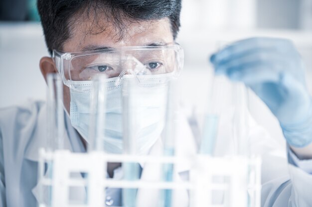 Asian male scientist working in a laboratory. Vaccine development concept.