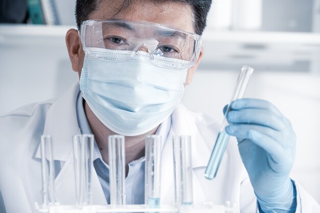 Asian male scientist working in a laboratory. Vaccine development concept.