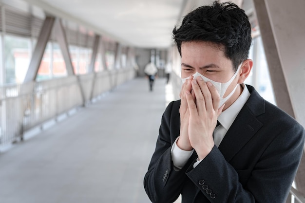 Asian man business in city of thailandHandsome man wearing protection medical mask covid19 or coronavirus from Infected personcorona protected Help protect For world and people stop virus warning