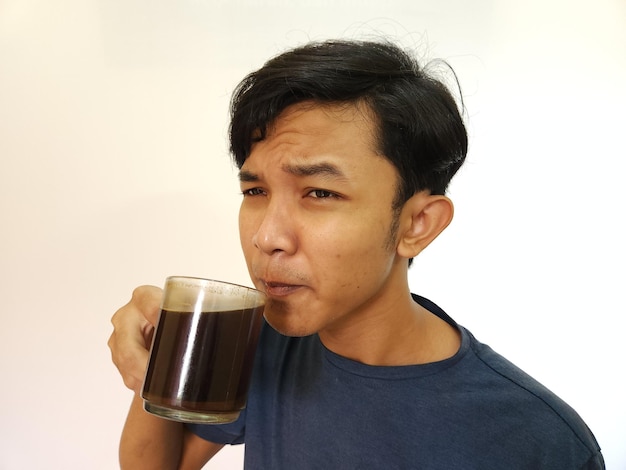 Asian man drink a shot of coffee