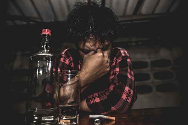 Asian man drink vodka alone at home on night timethailand\
peoplestress man drunk concept