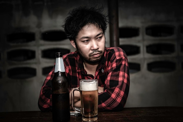 Asian man drink vodka alone at home on night timethailand\
peoplestress man drunk concept