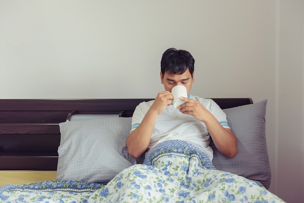 Asian man drinking coffee in morning time at home