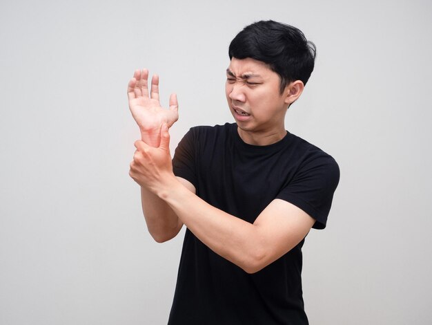 Asian man feels pain his wrist isolated